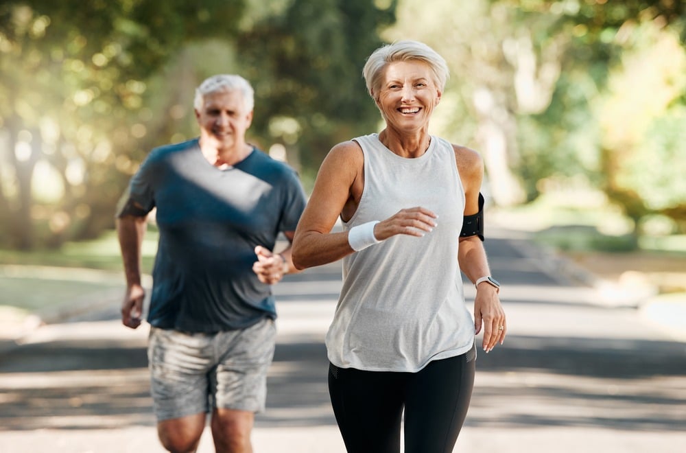 cardio-exercises older couple jogging outdoors, embodying a heart smart lifestyle